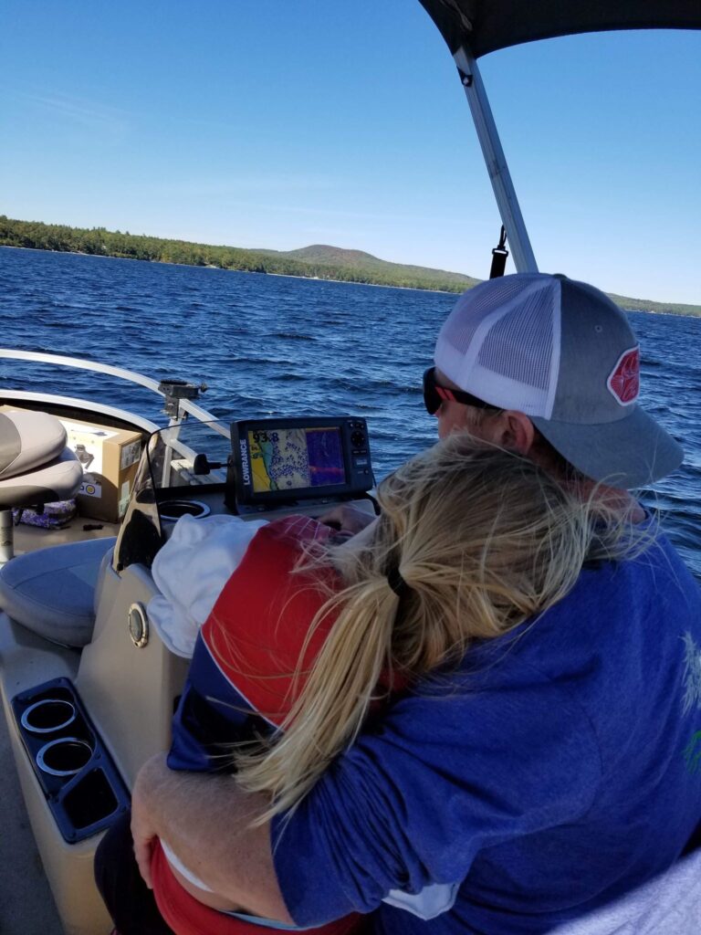 Photo of master fisherman Charlie McGee and his daughter, enjoying a cruise on a lake in southern Maine.